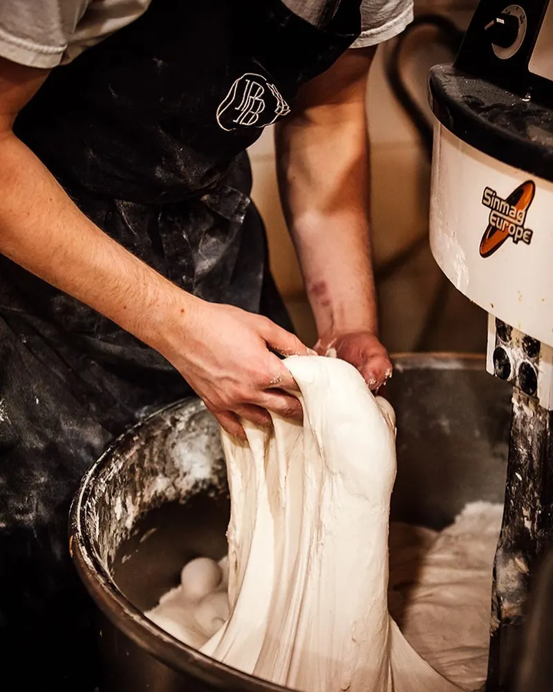 Dough being lifted from the spiral mixer